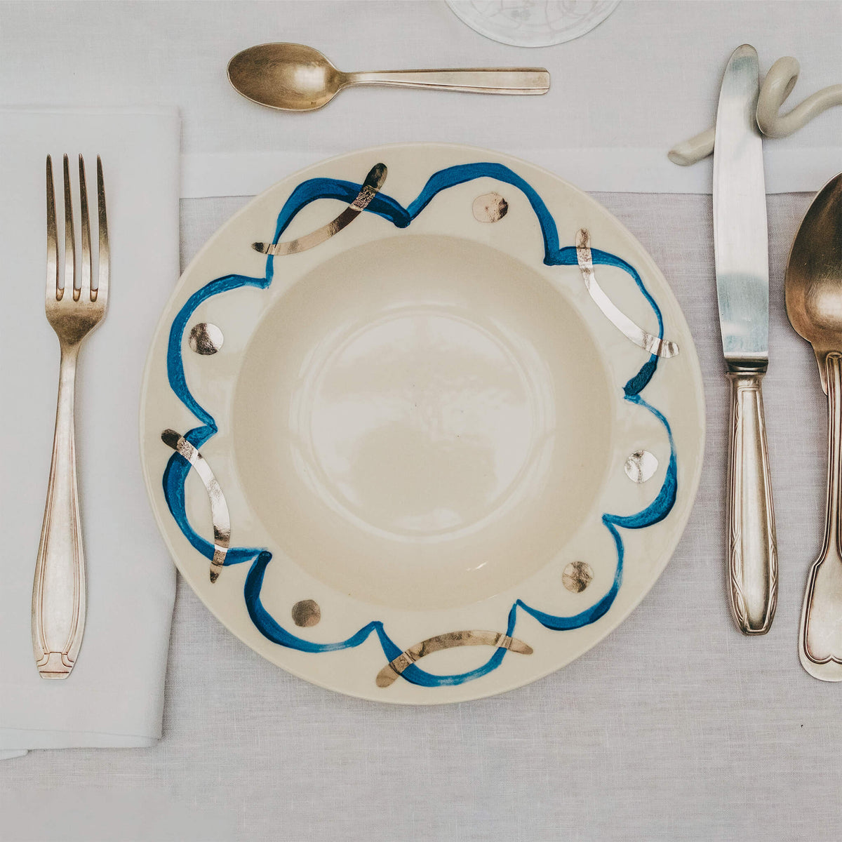 Assiette en porcelaine décorée au platine par l'atelier grand soleil, à Paris. Thème Art Déco.