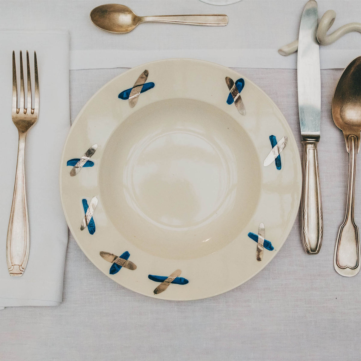 Assiette en porcelaine décorée au platine par l'atelier grand soleil, à Paris. Thème Art Déco.
