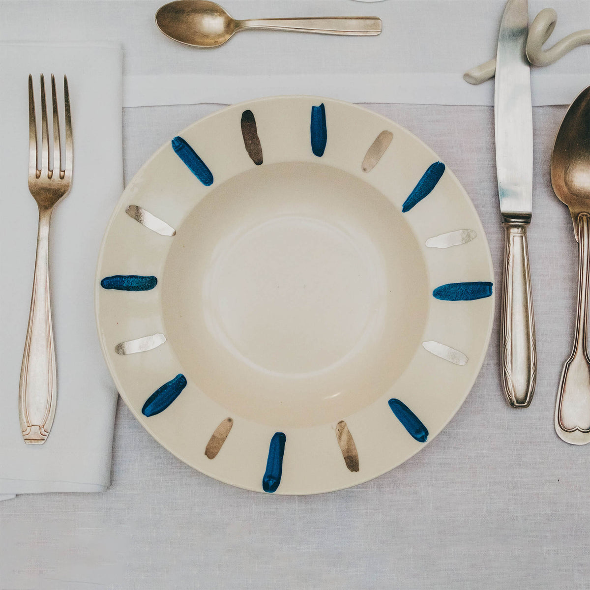Assiette en porcelaine décorée au platine par l'atelier grand soleil, à Paris. Thème Art Déco.